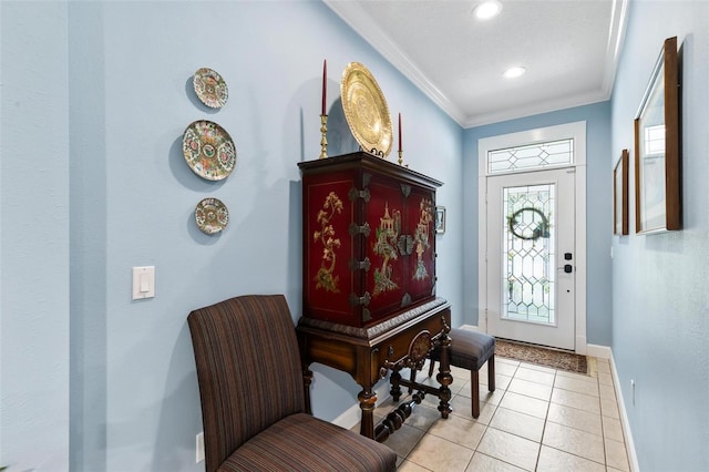 entryway with light tile patterned floors and ornamental molding