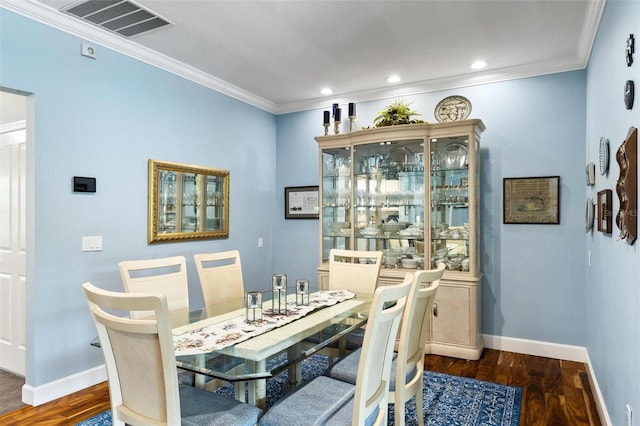 dining room with dark hardwood / wood-style floors and crown molding