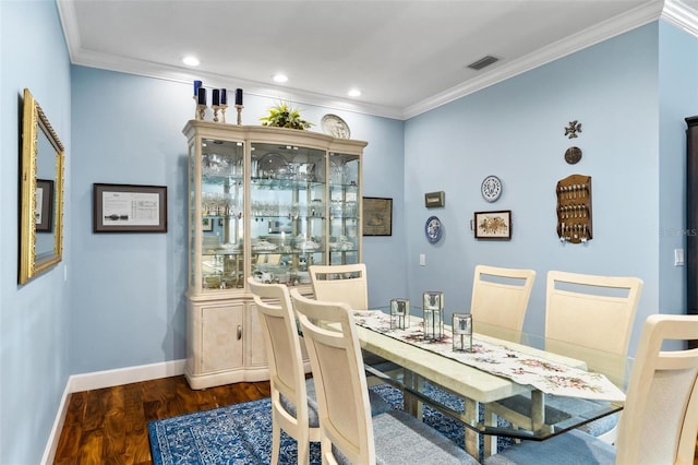 dining area with dark hardwood / wood-style floors and ornamental molding