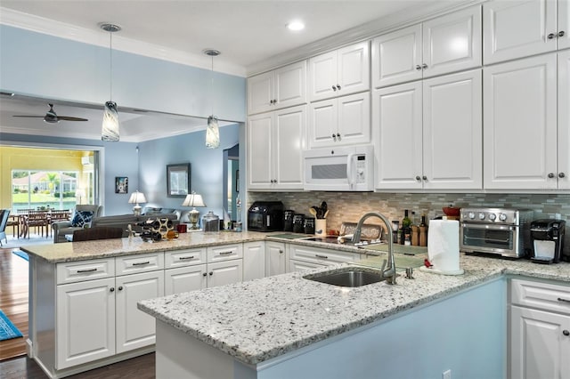 kitchen featuring white cabinetry, dark hardwood / wood-style floors, ceiling fan, and pendant lighting