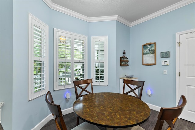 dining space with wood-type flooring, a textured ceiling, plenty of natural light, and crown molding