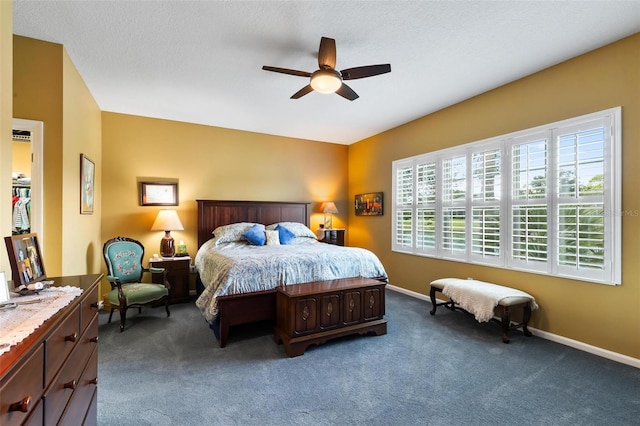 bedroom with a textured ceiling, carpet, and ceiling fan