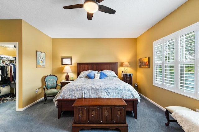 carpeted bedroom featuring a spacious closet, ceiling fan, and a closet