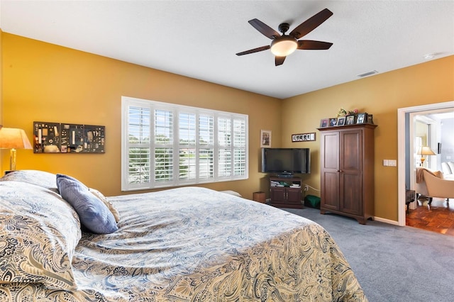 bedroom with ceiling fan and carpet floors