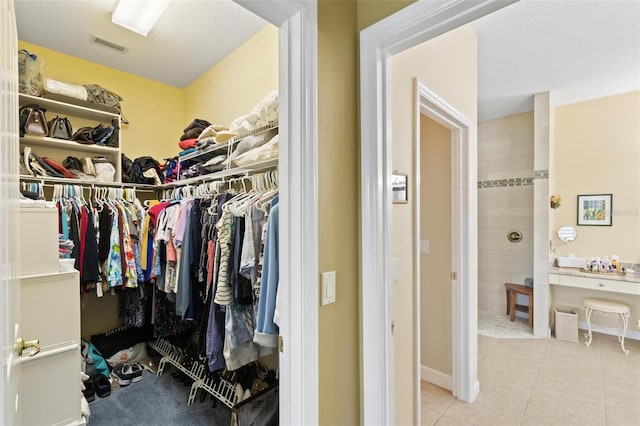 spacious closet featuring light tile patterned floors