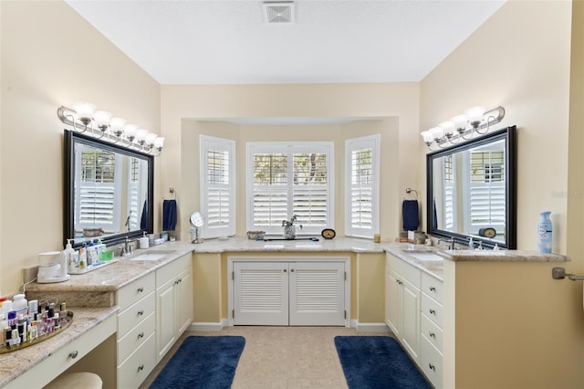 bathroom with vanity, a healthy amount of sunlight, and tile patterned flooring