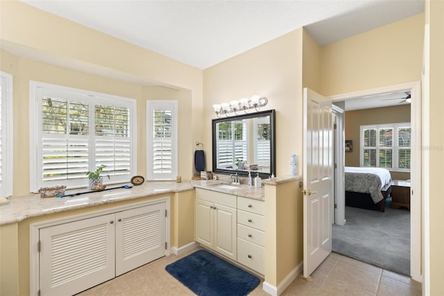 bathroom featuring vanity, tile patterned flooring, ceiling fan, and a healthy amount of sunlight