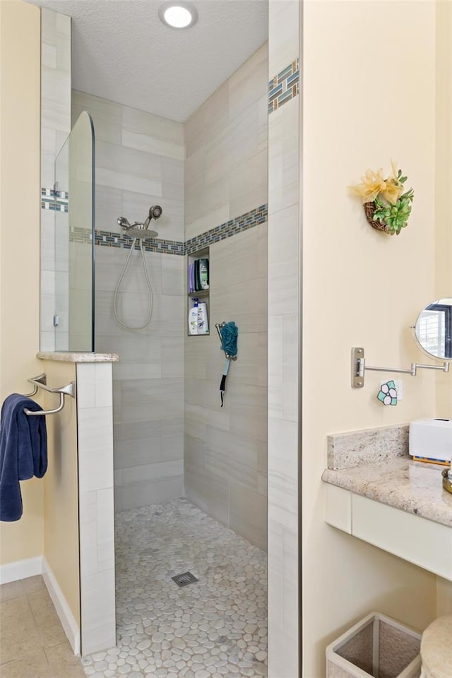 bathroom with a tile shower