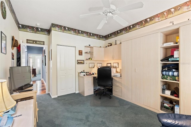 home office with ceiling fan and dark colored carpet