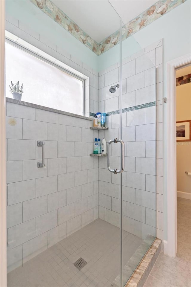 bathroom with walk in shower and tile patterned floors