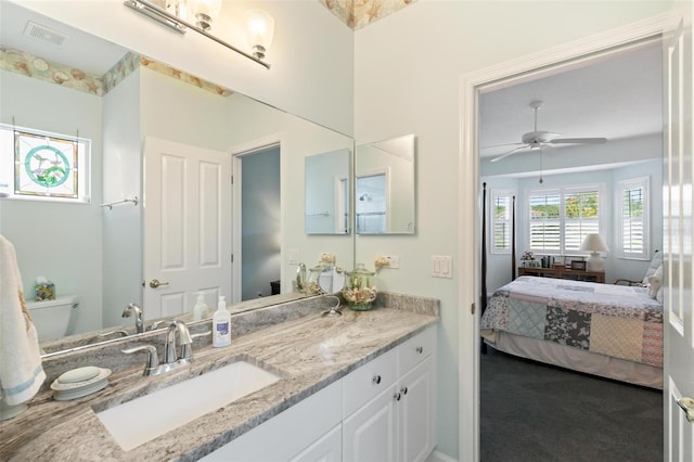 bathroom with ceiling fan, vanity, and toilet