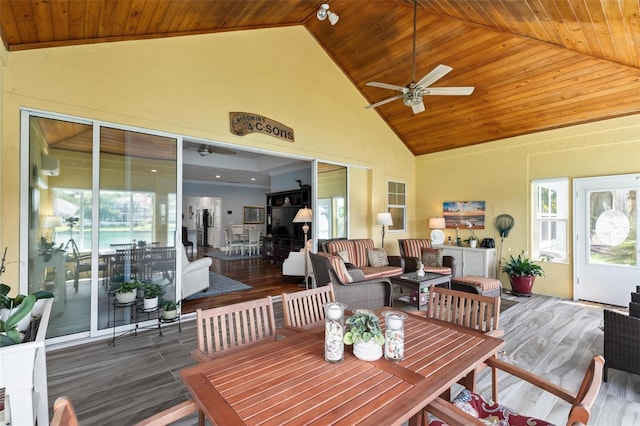 sunroom with ceiling fan, a wealth of natural light, and wooden ceiling