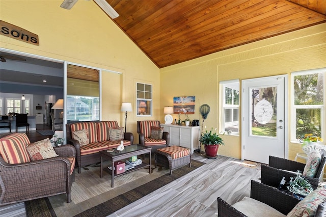 sunroom featuring ceiling fan, vaulted ceiling, plenty of natural light, and wood ceiling