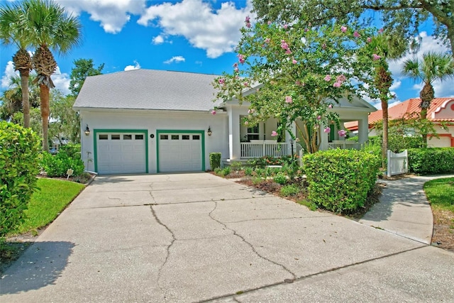 view of front of house with covered porch and a garage