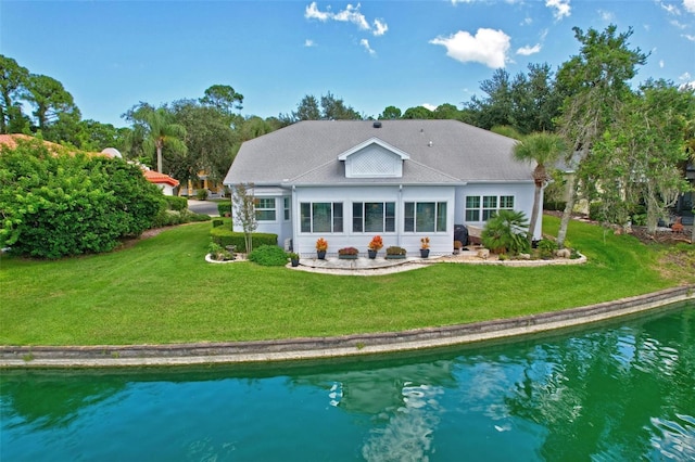 rear view of property with a yard