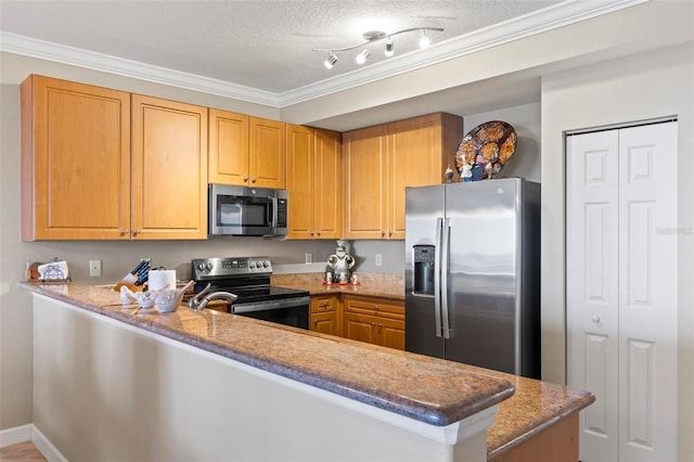 kitchen with light stone counters, appliances with stainless steel finishes, a peninsula, and ornamental molding