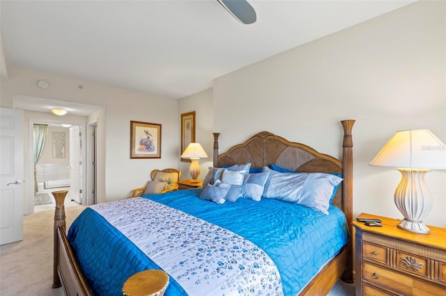 bedroom with connected bathroom, light carpet, and ceiling fan