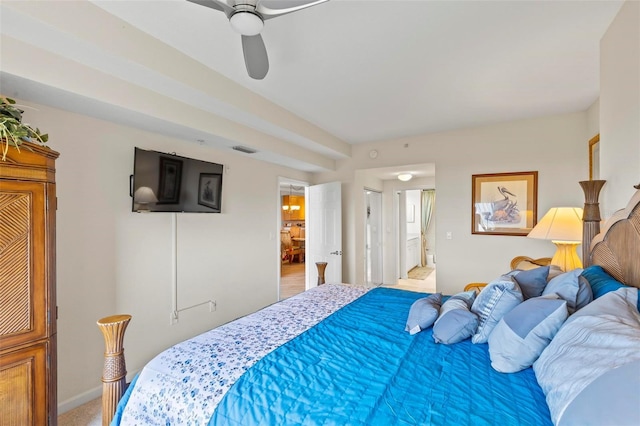 bedroom featuring a ceiling fan, visible vents, ensuite bathroom, and baseboards