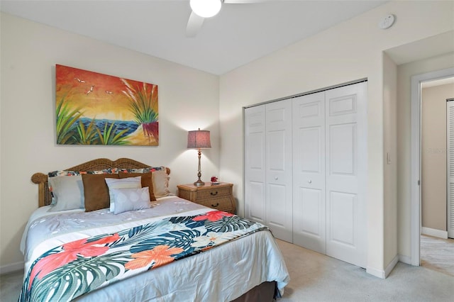 carpeted bedroom featuring a closet and ceiling fan