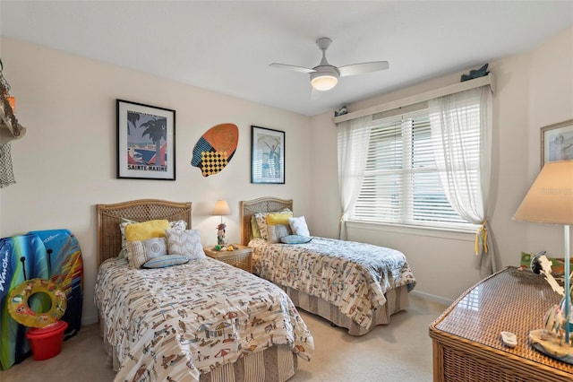 carpeted bedroom with baseboards and ceiling fan