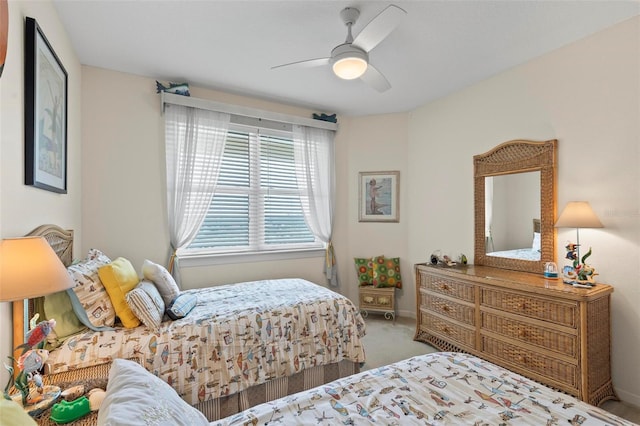 carpeted bedroom featuring a ceiling fan and baseboards