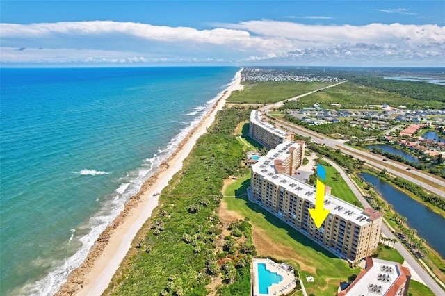 bird's eye view with a water view and a view of the beach