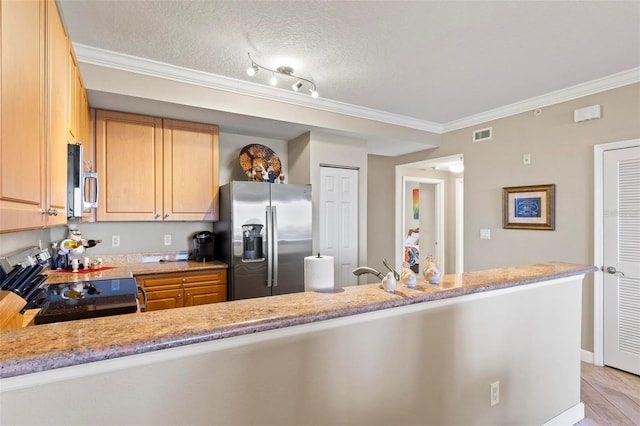 kitchen featuring visible vents, light stone counters, stainless steel appliances, a peninsula, and crown molding