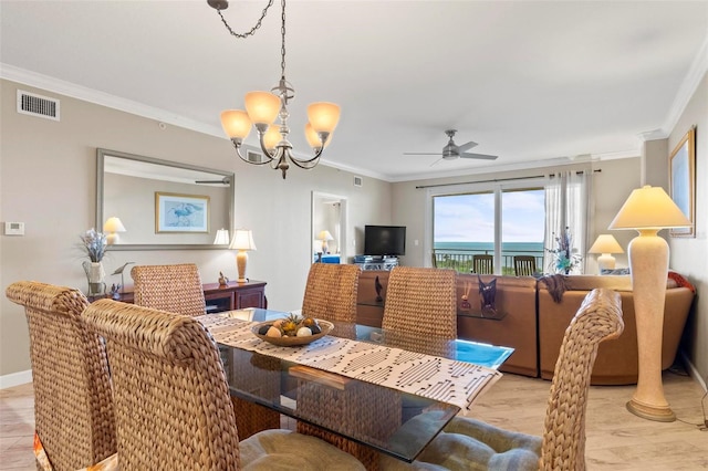 dining space featuring ceiling fan with notable chandelier, ornamental molding, and light wood-type flooring