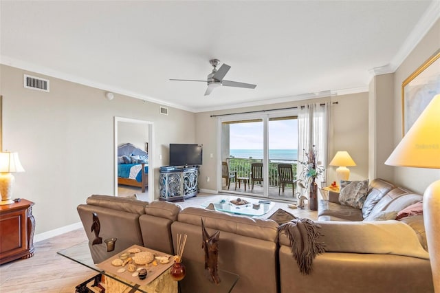 living room featuring ornamental molding, visible vents, and ceiling fan