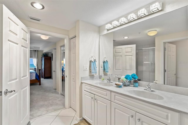 ensuite bathroom with a sink, ensuite bath, a stall shower, and double vanity