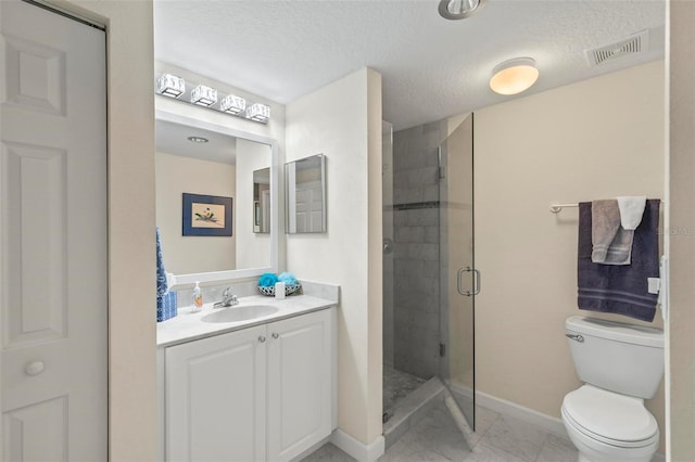 bathroom featuring vanity, a shower stall, visible vents, and a textured ceiling