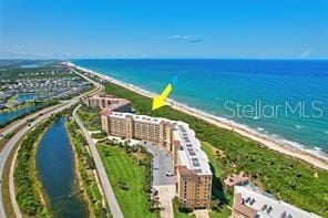 drone / aerial view with a beach view and a water view