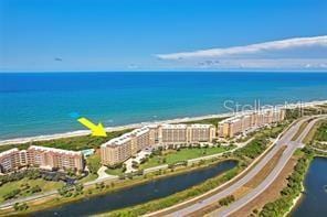 drone / aerial view featuring a view of city and a water view