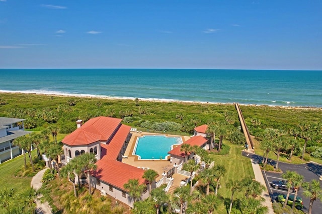 birds eye view of property featuring a beach view and a water view