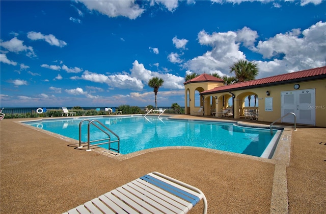 view of swimming pool featuring a patio area