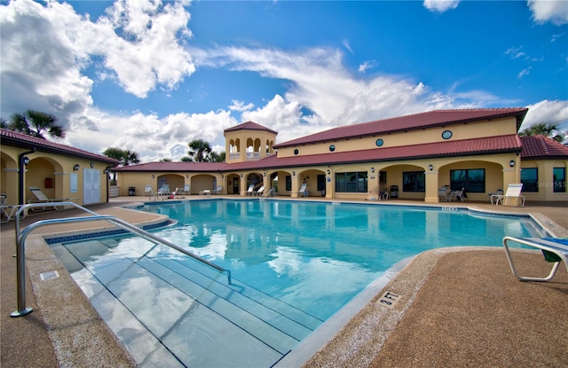 view of swimming pool with a patio