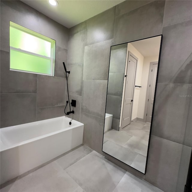 bathroom featuring tile patterned flooring and tile walls