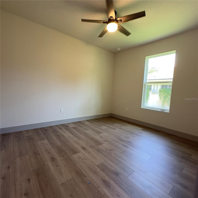 unfurnished room featuring hardwood / wood-style floors and ceiling fan