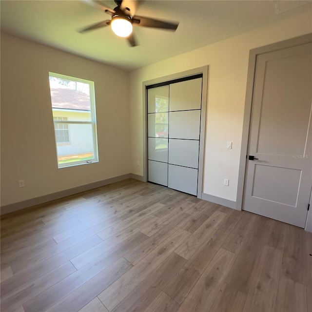 unfurnished bedroom featuring ceiling fan and light wood-type flooring