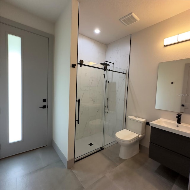 bathroom with tile patterned floors, vanity, walk in shower, and toilet