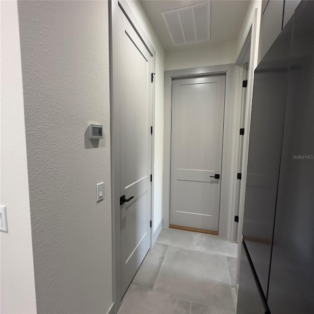 hallway featuring light tile patterned floors