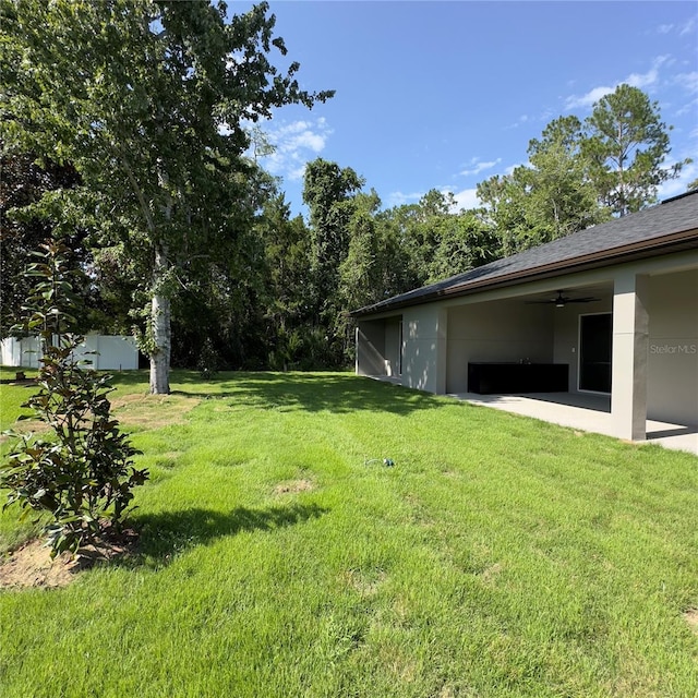 view of yard featuring ceiling fan