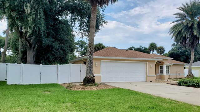 ranch-style house featuring a garage and a front yard