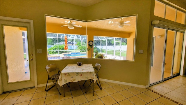 dining room featuring ceiling fan, light tile patterned floors, and a wealth of natural light