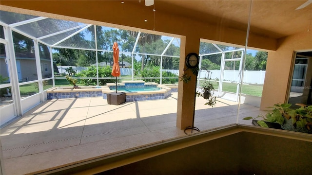 unfurnished sunroom featuring ceiling fan