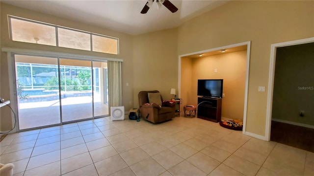 sitting room with ceiling fan and light tile patterned flooring