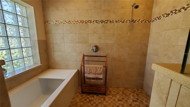 bathroom with plus walk in shower, tile patterned flooring, and tile walls