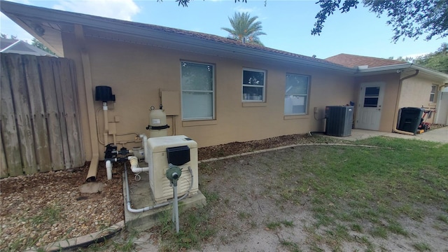 rear view of property featuring cooling unit