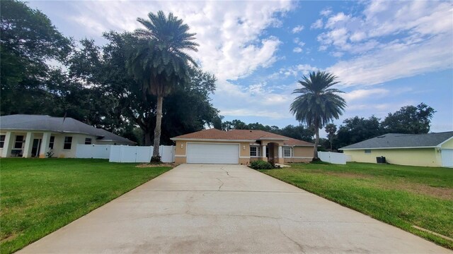 single story home featuring a front lawn and a garage