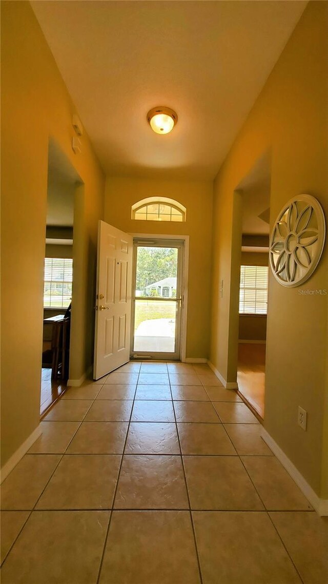 doorway to outside with tile patterned floors